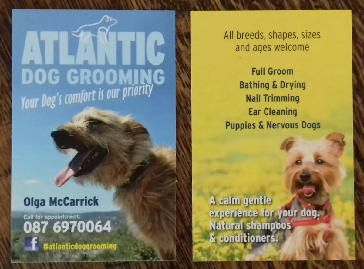 Atlantic Dog Grooming business card showing a happy terrier and services offered